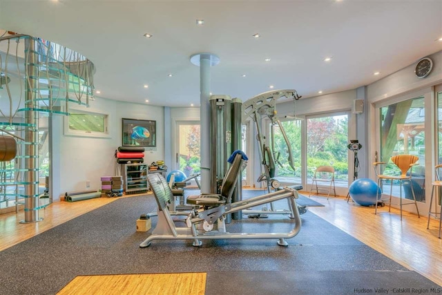 exercise room with recessed lighting and wood finished floors