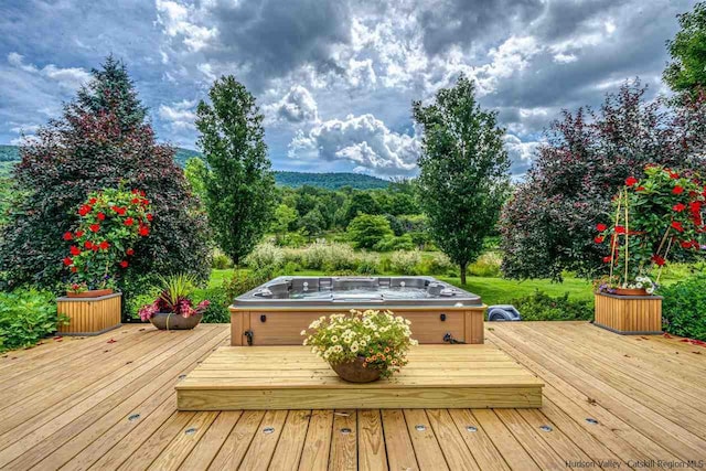 wooden terrace with an outdoor hot tub