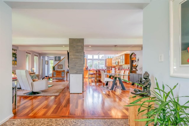 entryway featuring decorative columns and wood finished floors