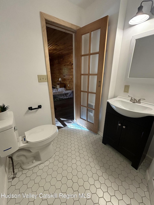 bathroom featuring tile patterned flooring, vanity, and toilet