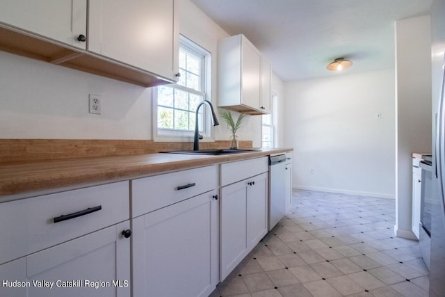 kitchen featuring white cabinetry, sink, and stainless steel dishwasher