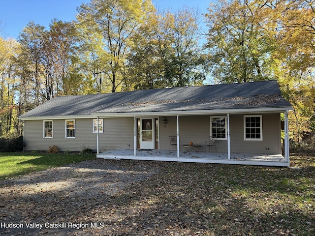 rear view of property featuring a porch