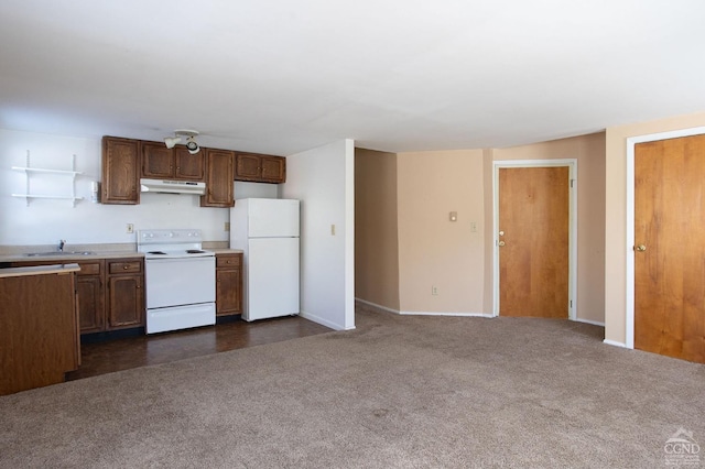826 Rte 203, Austerlitz, NY 12165 - kitchen with white appliances, under cabinet range hood, light countertops, dark colored carpet, and brown cabinets