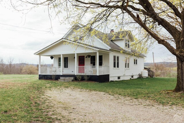 422 County Route 9, Ghent, NY 12075 - view of front of home with a porch, a chimney, a front yard, and roof with shingles