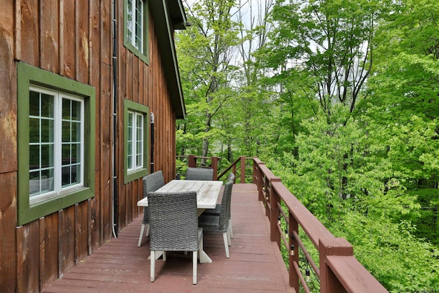 wooden terrace with outdoor dining space