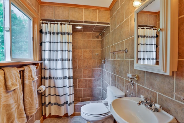 bathroom with a sink, a tile shower, tile walls, and toilet