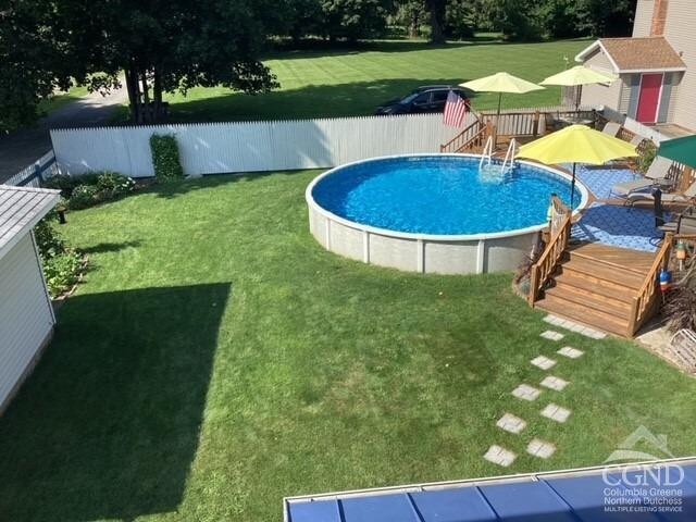 view of swimming pool featuring a deck