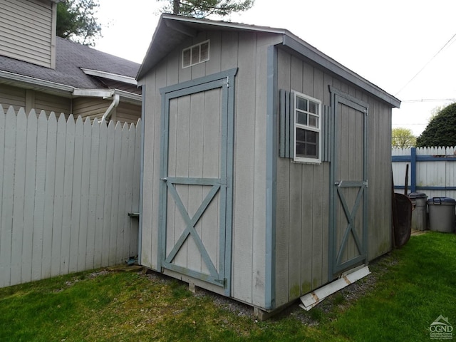 view of shed with fence