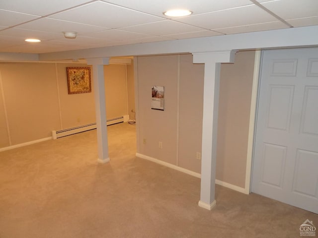 finished basement featuring a baseboard radiator, light carpet, a paneled ceiling, baseboards, and recessed lighting