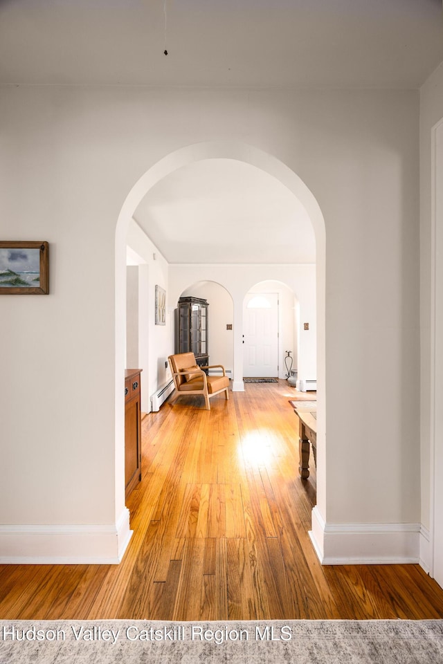 219 Rte 32, New Paltz, NY 12561 - corridor with light wood finished floors, arched walkways, and baseboard heating