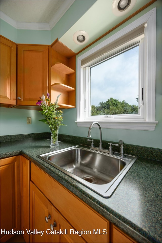 219 Rte 32, New Paltz, NY 12561 - kitchen featuring brown cabinets, dark countertops, and ornamental molding