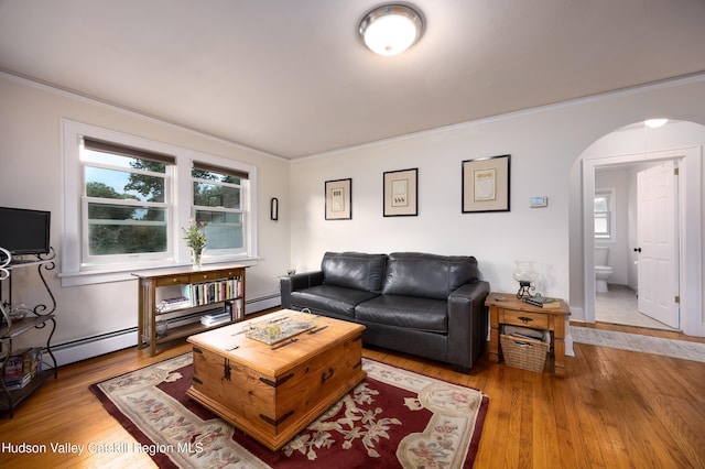 219 Rte 32, New Paltz, NY 12561 - living room featuring arched walkways, wood finished floors, ornamental molding, and a baseboard heating unit