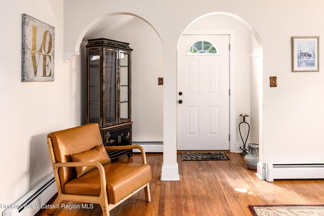 219 Rte 32, New Paltz, NY 12561 - entryway with arched walkways, wood finished floors, and a baseboard radiator