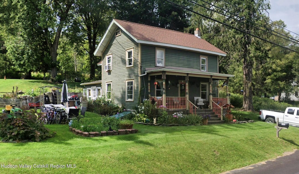1283 County Route 7, Ancram, NY 12502 - view of front of house featuring a front yard, covered porch, and a chimney