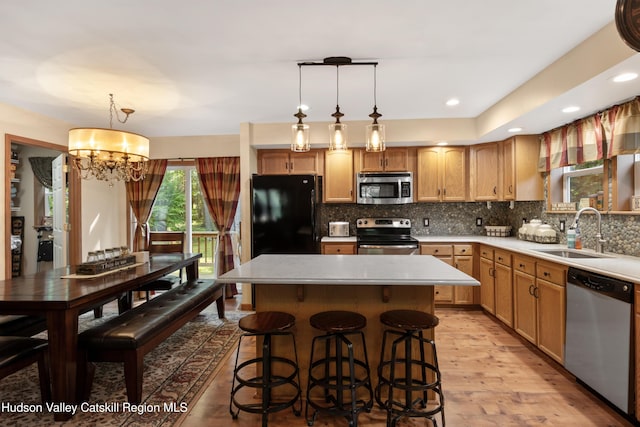 190 Deer Run Rd, Ashland, NY 12407 - kitchen featuring stainless steel appliances, a sink, light wood-style flooring, a chandelier, and a center island