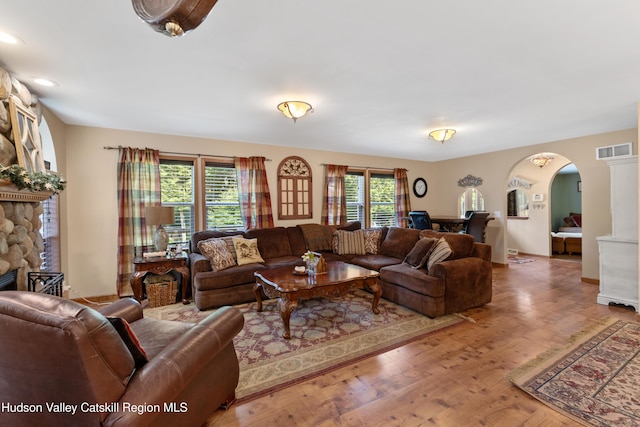 190 Deer Run Rd, Ashland, NY 12407 - living area with arched walkways, wood finished floors, a stone fireplace, and recessed lighting