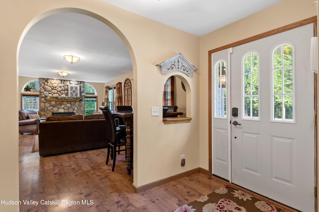 190 Deer Run Rd, Ashland, NY 12407 - entryway featuring arched walkways, wood finished floors, baseboards, and a stone fireplace