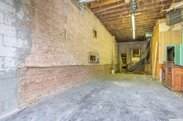8-10 Park Pl, Hudson, NY 12534 - miscellaneous room featuring unfinished concrete flooring, stairs, and brick wall