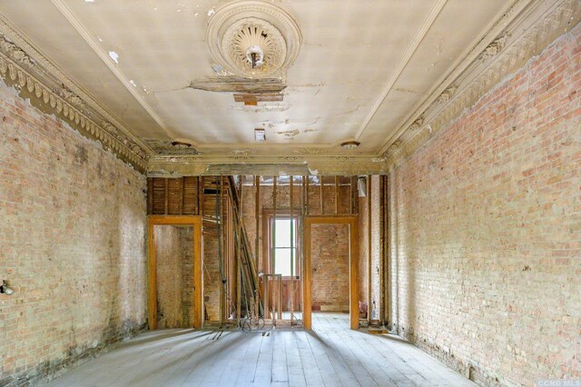8-10 Park Pl, Hudson, NY 12534 - miscellaneous room with hardwood / wood-style floors and brick wall