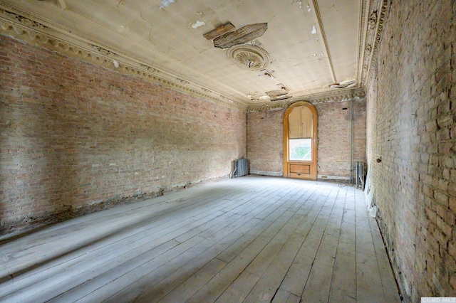 8-10 Park Pl, Hudson, NY 12534 - empty room featuring hardwood / wood-style floors and brick wall