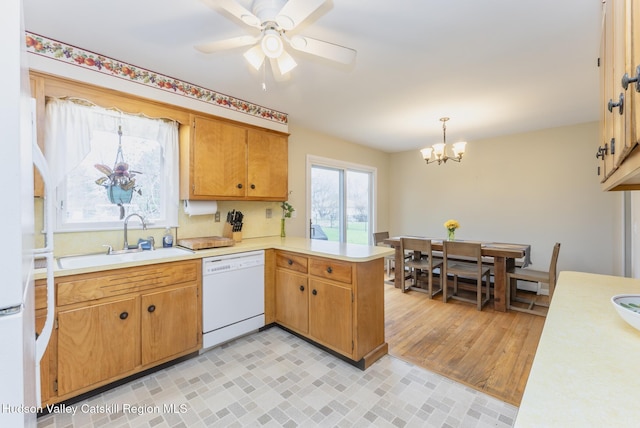 121 Rayna St, Hurley, NY 12443 - kitchen with white dishwasher, a sink, a peninsula, and light countertops