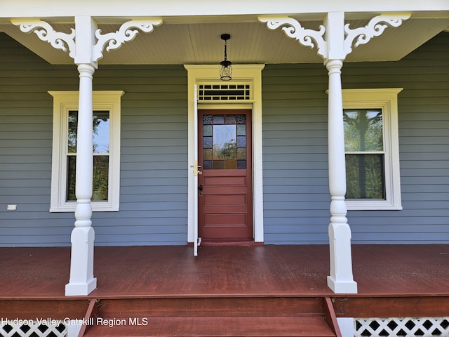 view of exterior entry featuring a porch