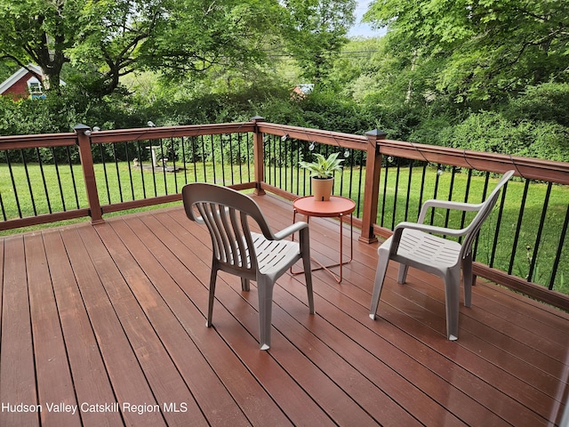 wooden deck featuring a yard