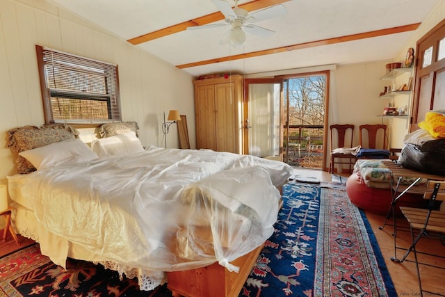 bedroom featuring ceiling fan and beamed ceiling