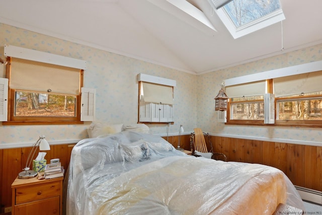 bedroom featuring a baseboard radiator, ornamental molding, and vaulted ceiling with skylight