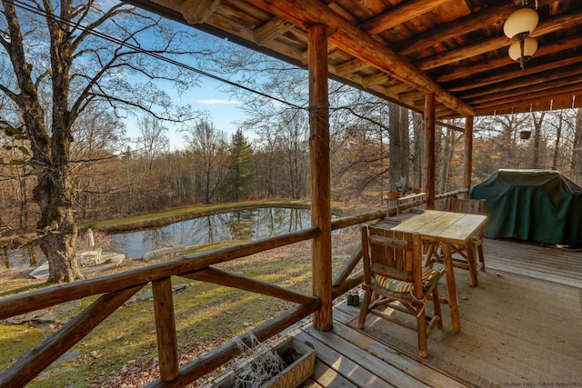 wooden terrace featuring a water view and grilling area