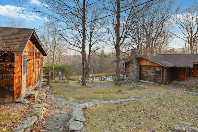 view of yard with a water view and a shed