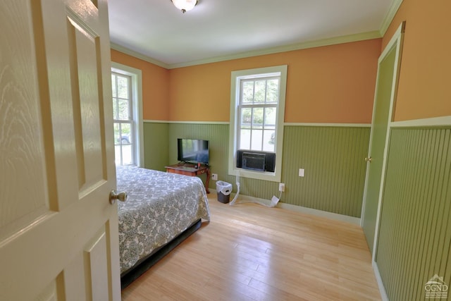 630 County Route 11, Ancram, NY 12502 - bedroom featuring a wainscoted wall, multiple windows, wood finished floors, and ornamental molding