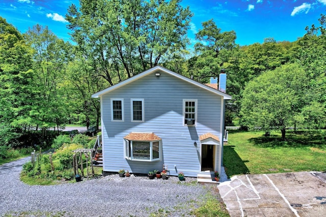 630 County Route 11, Ancram, NY 12502 - traditional home featuring a chimney, a front yard, and uncovered parking