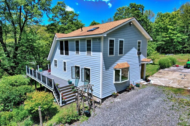 630 County Route 11, Ancram, NY 12502 - view of front of home with a deck, roof with shingles, and a patio