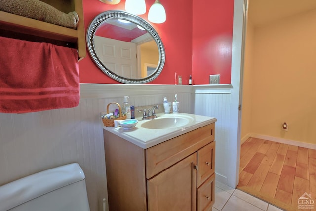 630 County Route 11, Ancram, NY 12502 - half bathroom with wainscoting, vanity, toilet, and tile patterned floors