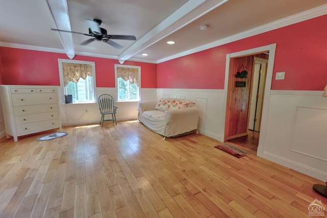 630 County Route 11, Ancram, NY 12502 - sitting room featuring ceiling fan, a wainscoted wall, light wood-style floors, beam ceiling, and crown molding