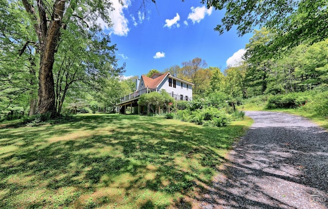 630 County Route 11, Ancram, NY 12502 - view of side of home with a deck, a lawn, and a forest view