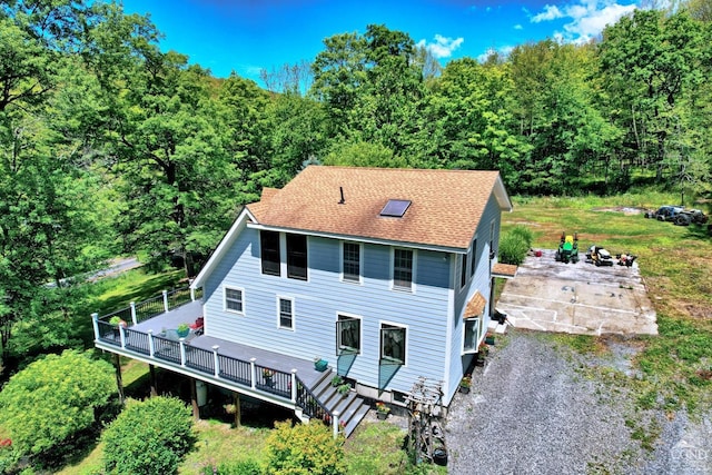630 County Route 11, Ancram, NY 12502 - view of front of property featuring a deck, a wooded view, and roof with shingles