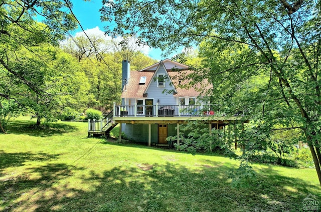 630 County Route 11, Ancram, NY 12502 - back of house featuring a deck, stairway, a chimney, and a lawn