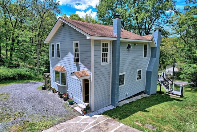 630 County Route 11, Ancram, NY 12502 - rear view of house with a chimney, a lawn, and roof with shingles