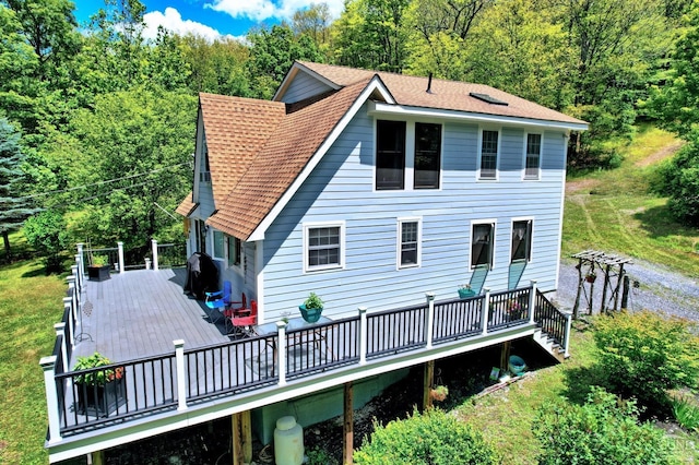 630 County Route 11, Ancram, NY 12502 - back of house featuring a deck, a shingled roof, and a view of trees