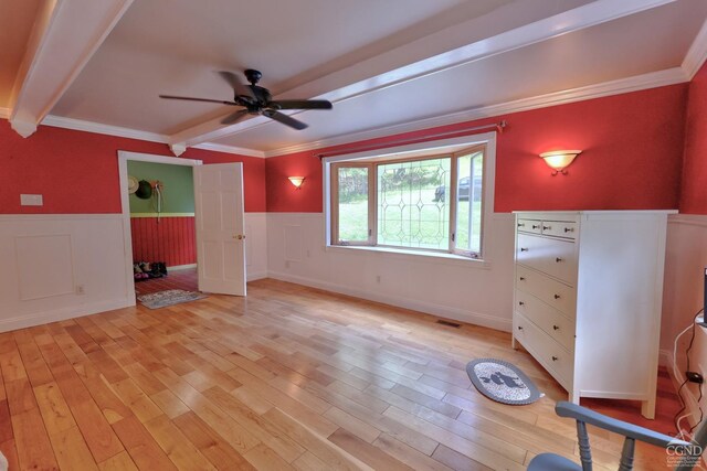 630 County Route 11, Ancram, NY 12502 - unfurnished bedroom with wainscoting, light wood-style floors, crown molding, beamed ceiling, and a ceiling fan