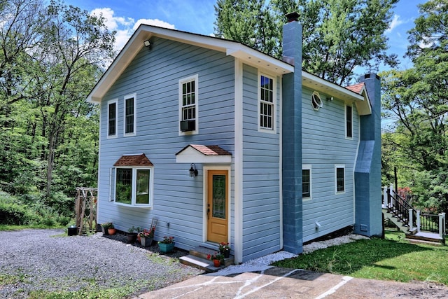 630 County Route 11, Ancram, NY 12502 - view of front of house with a chimney, entry steps, and stairs