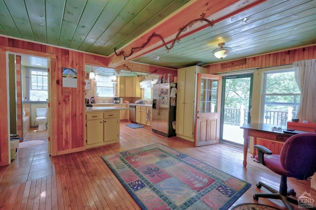 630 County Route 11, Ancram, NY 12502 - kitchen featuring stainless steel appliances, light countertops, light wood finished floors, wood ceiling, and wooden walls