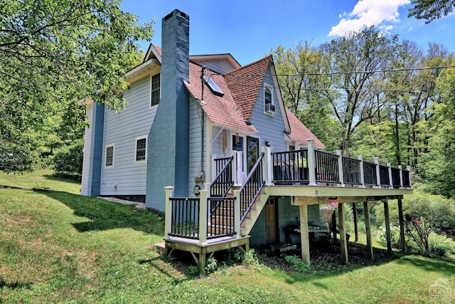 630 County Route 11, Ancram, NY 12502 - rear view of property featuring a yard, a deck, a chimney, and a shingled roof
