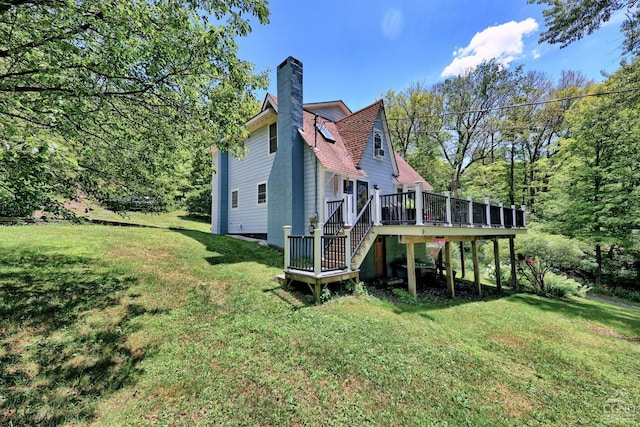 630 County Route 11, Ancram, NY 12502 - rear view of property with a chimney, a lawn, a deck, and stairway