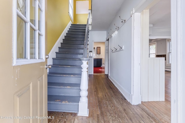 stairs featuring baseboards and wood finished floors