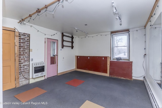 garage with heating unit and a baseboard heating unit