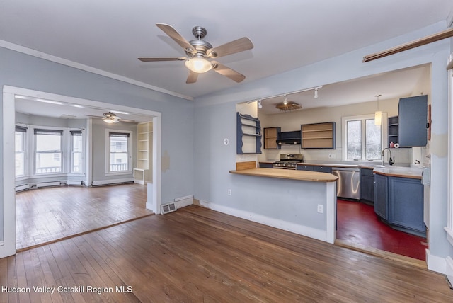 kitchen featuring blue cabinets, open shelves, a ceiling fan, and appliances with stainless steel finishes