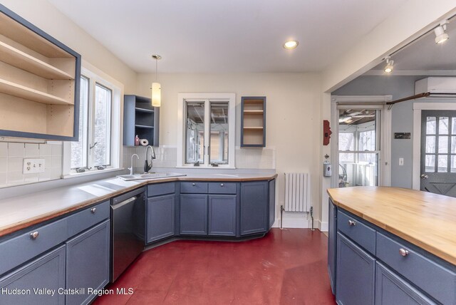kitchen featuring dishwasher, wooden counters, a sink, open shelves, and radiator